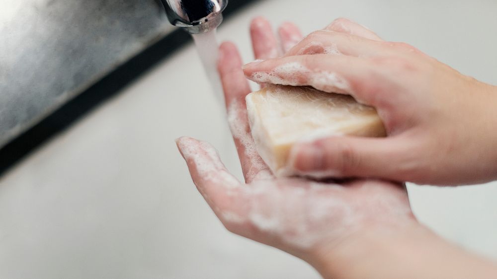Washing hands with a bar soap to prevent coronavirus contamination