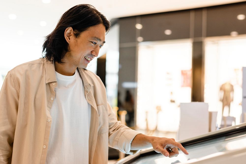 Man using a digital screen at a shopping mall