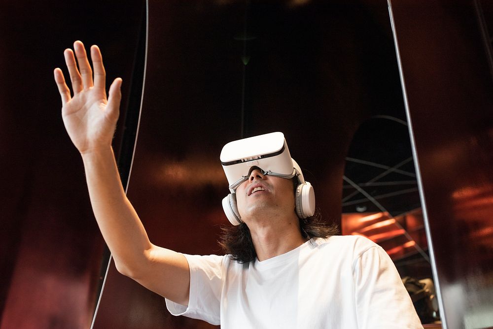 Asian man watching movie via VR headset