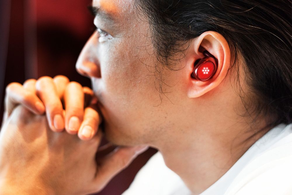 Man listening to music through wireless earbuds