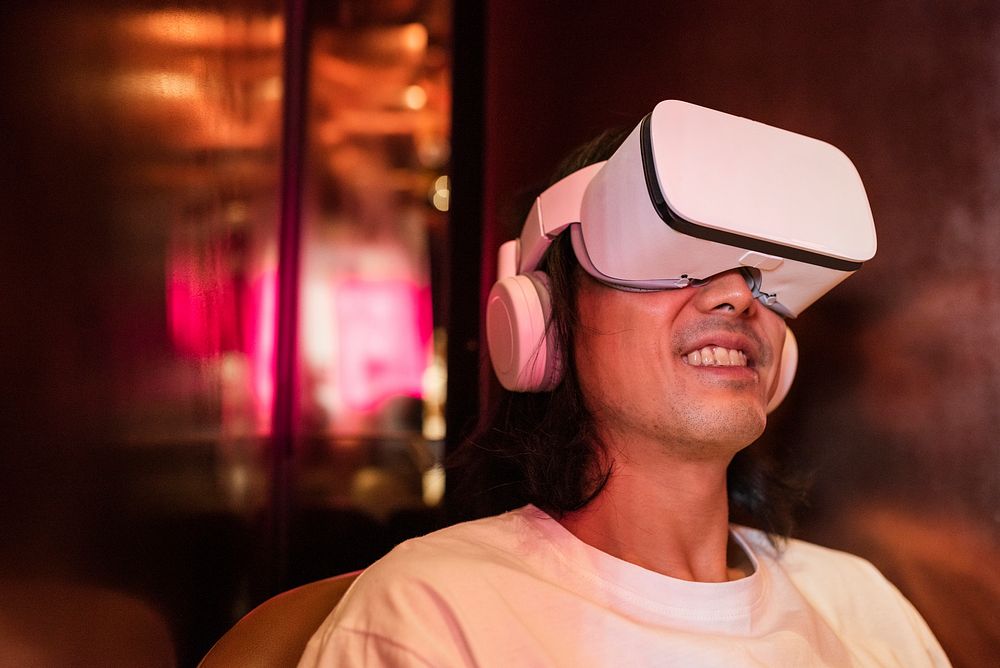 Asian man watching movie via VR headset