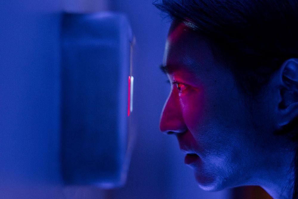 Iris scanner man using biometrics to unlock a door