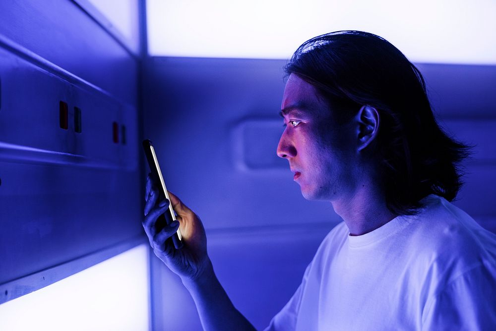 Man using a smartphone in the dark