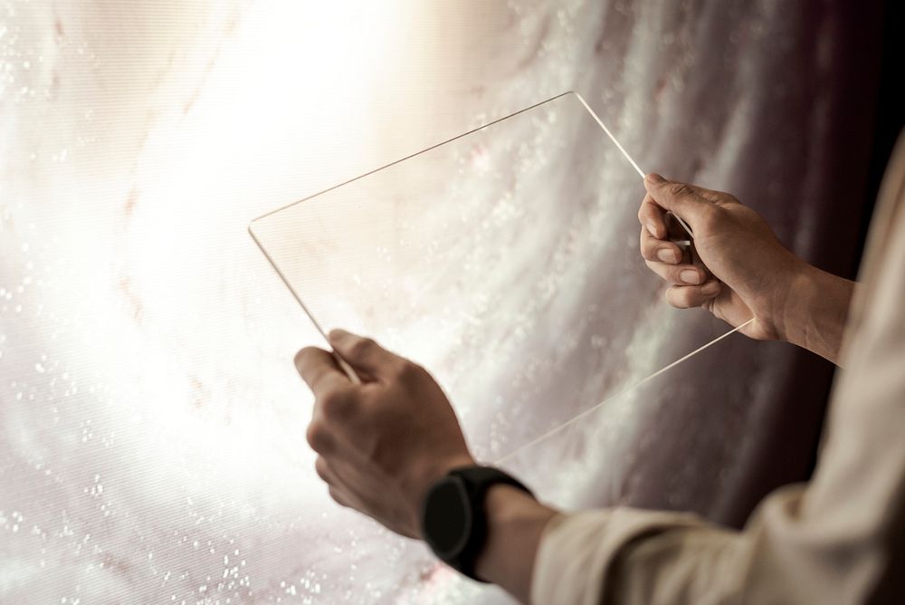 Girl holding transparent tablet in her hands