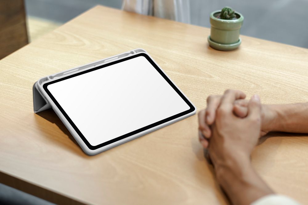 Blank digital tablet screen mockup psd on a wooden table