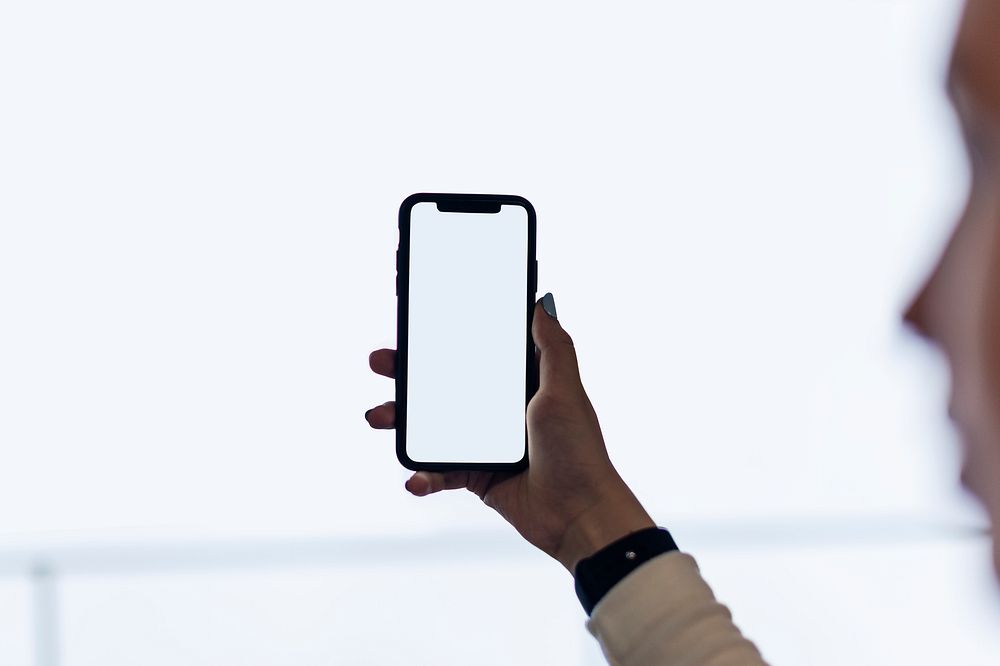 Girl holding a smartphone on white background