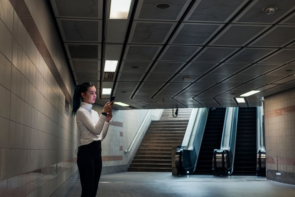 Asian girl waiting alone at the underground subway station