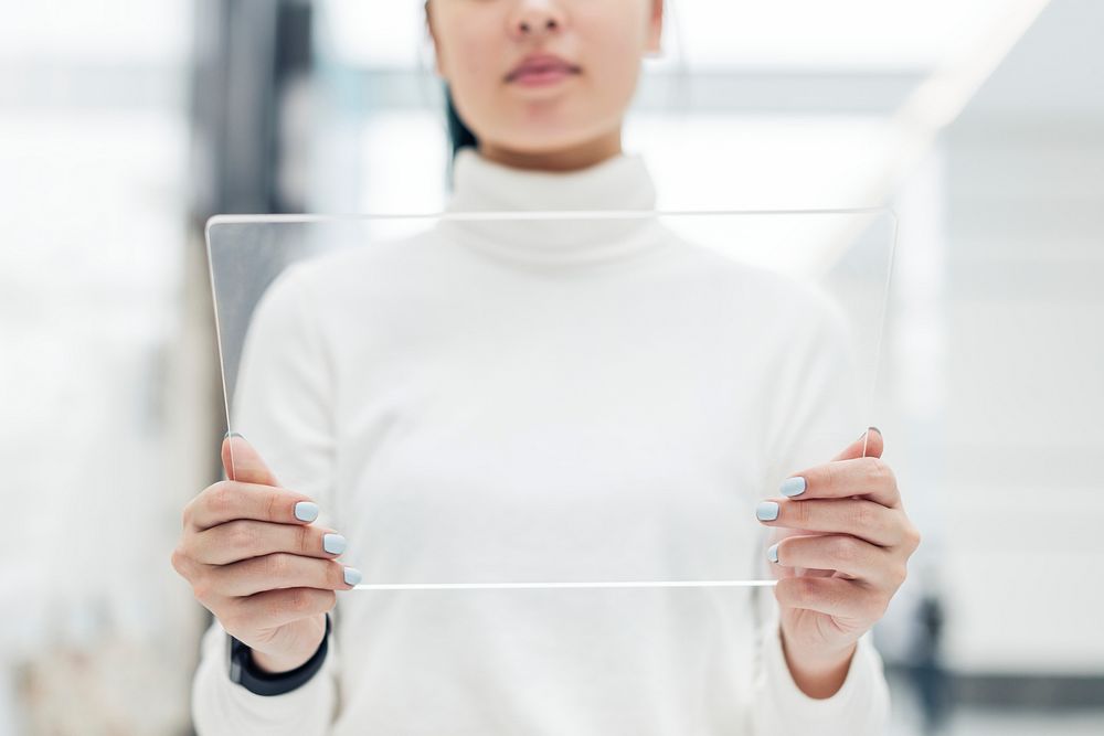 Scientist using a transparent digital screen at a research center