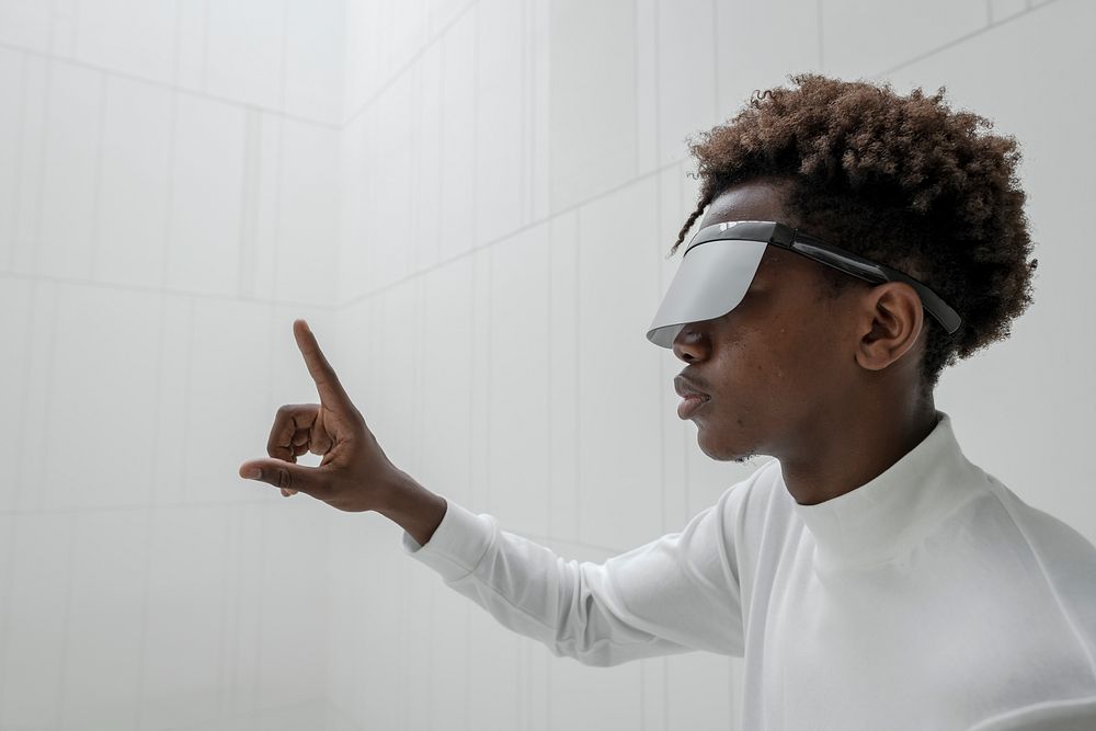 Man wearing smart glasses touching a virtual screen