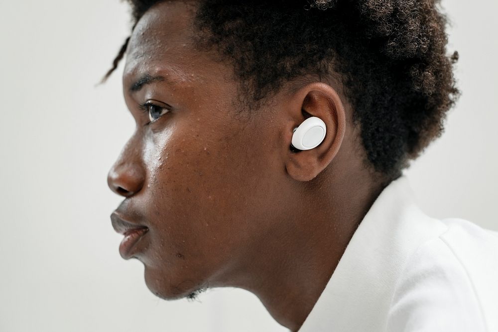 Man listening to music through wireless earbuds