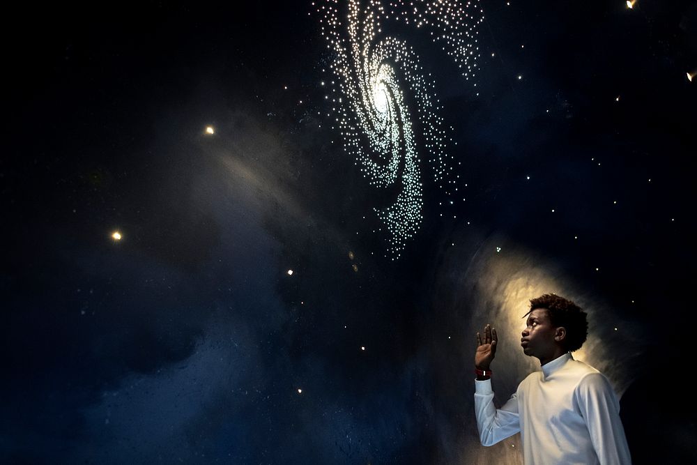 Man experiencing the universe at a planetarium 