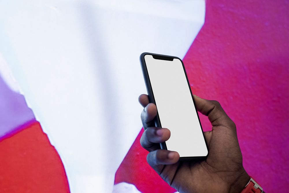 African man holding a smartphone screen