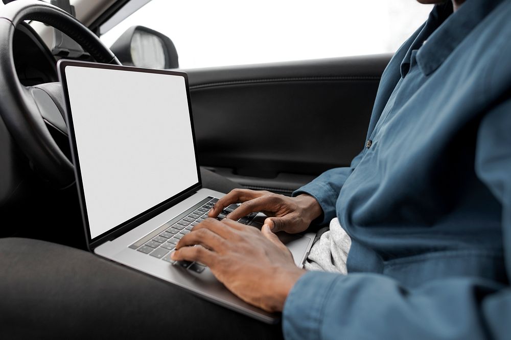 Researcher using a laptop while working on a new self driving car model