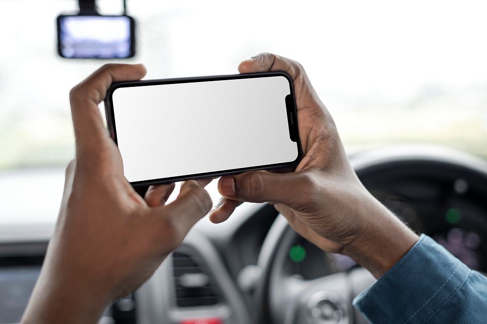 Phone screen mockup driver taking a photo in the car psd