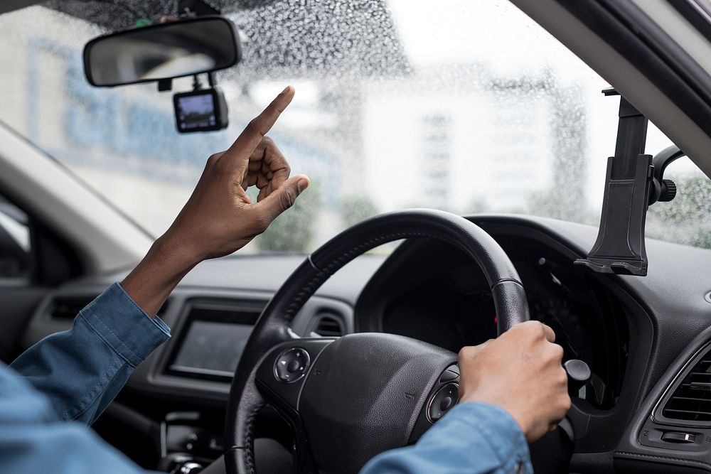 Man touching transparent window screen in a smart car