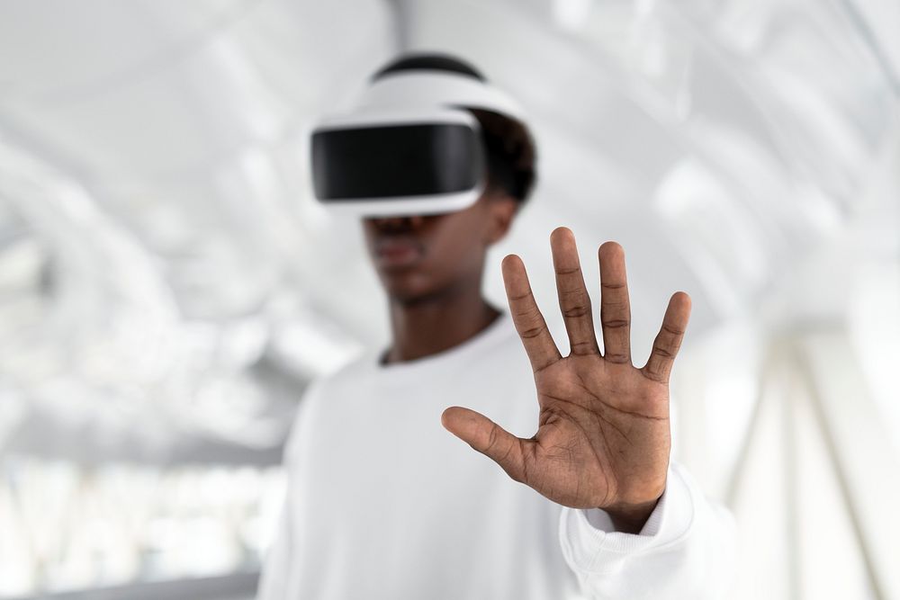 Man with VR headset touching a virtual screen