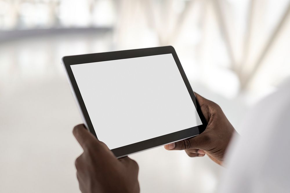 Man holding a white screen digital tablet