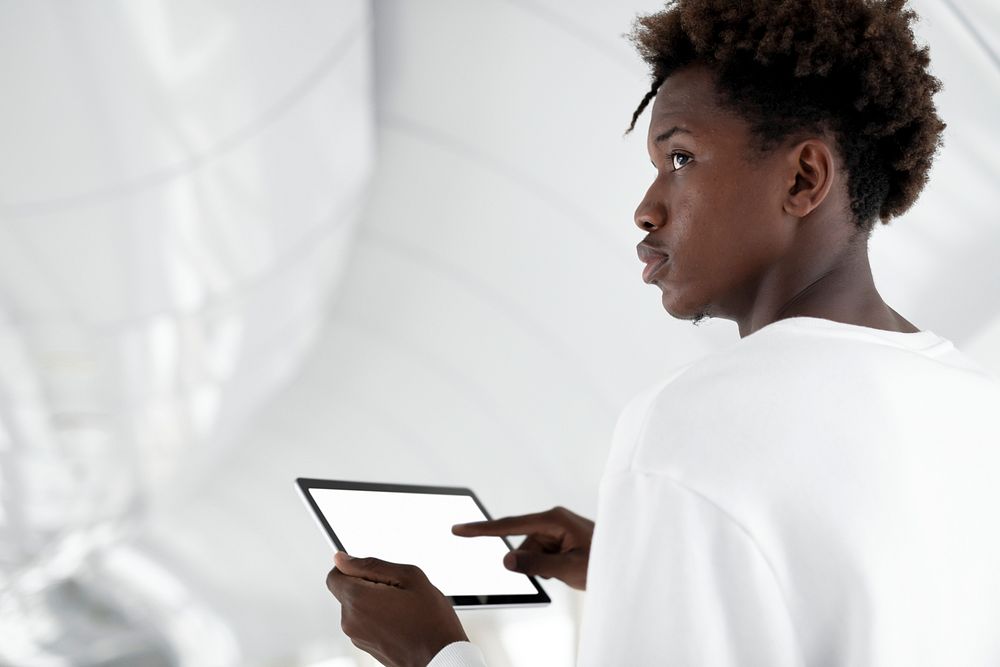 Man holding a white screen digital tablet
