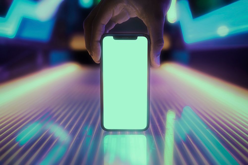 Smartphone screen mockup on glowing neon lights table psd