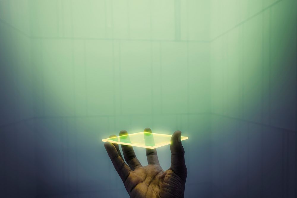 Hand holding hologram screen with design space