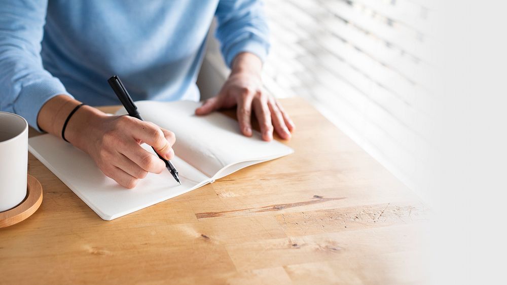 Man writing in a journal while at home in the new normal