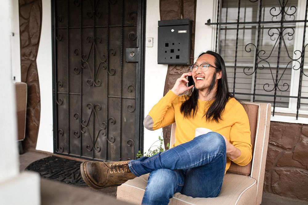 Asian man talking on the phone during covid 19 pandemic