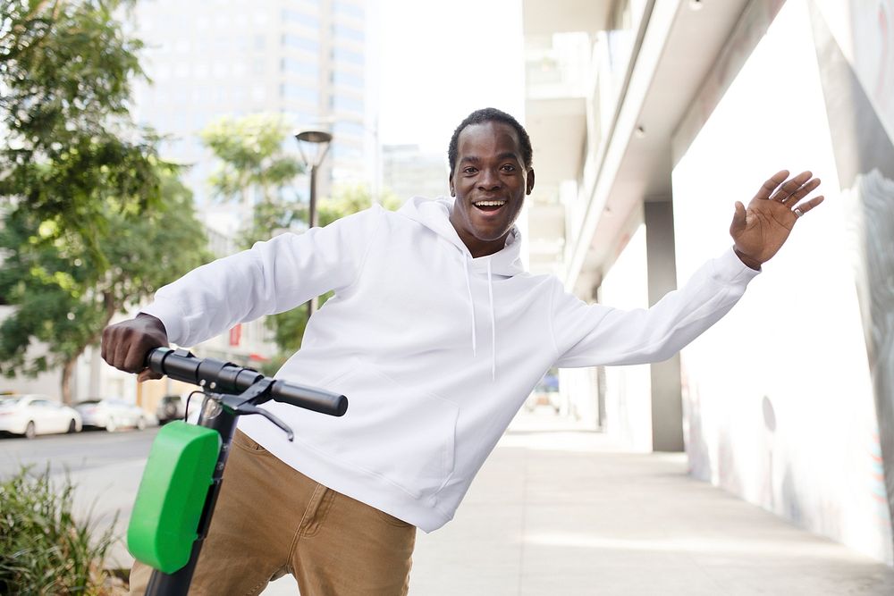 Streetwear white hoodie mockup psd man riding scooter stylish apparel