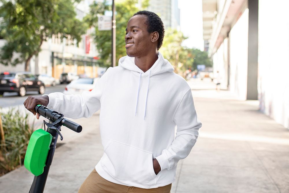 Streetwear white hoodie mockup psd man riding scooter stylish apparel