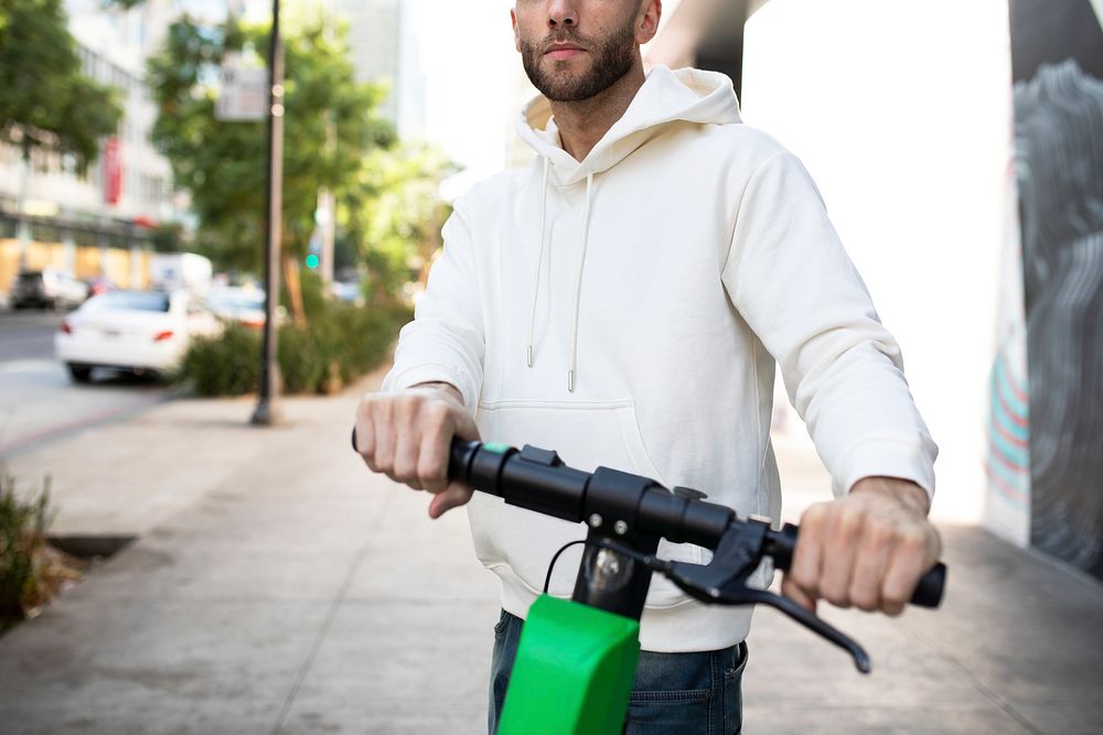 White hoodie mockup psd man riding scooter stylish apparel