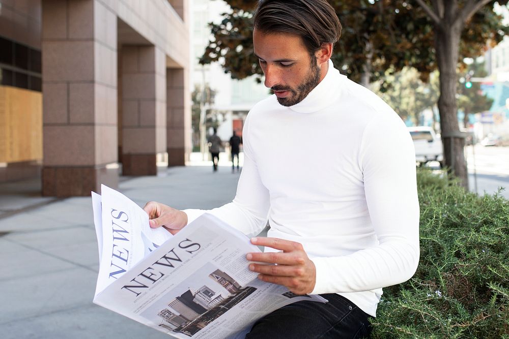 Businessman in turtleneck mockup psd reading newspaper in the city