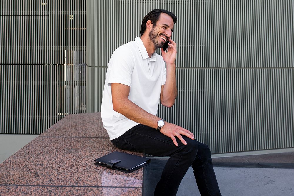 White polo shirt man talking on the phone menswear apparel fashion
