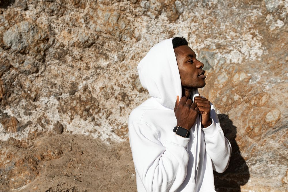 African American man in white hoodie posing outdoor photoshoot