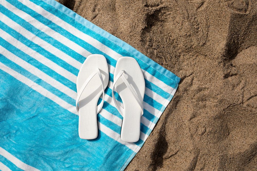 White sandals mockup psd on beach towel aerial view