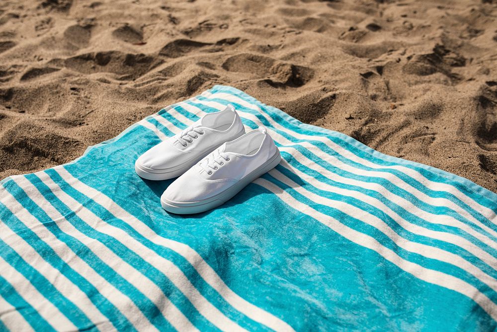 White sneakers on beach towel summer vibes photography