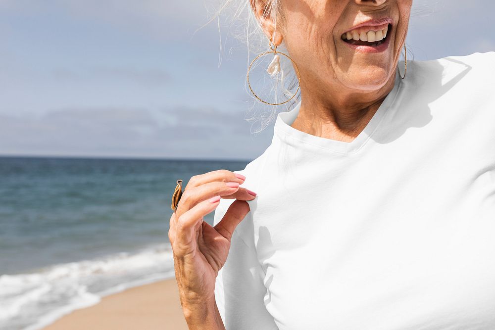 Senior woman in white tee at the beach