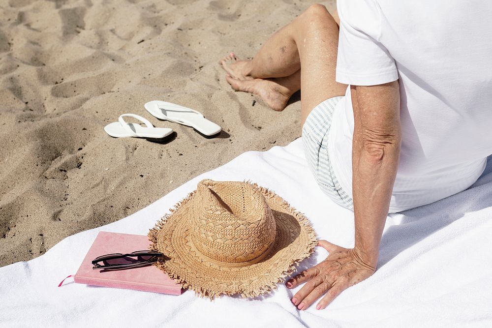 White beach towel psd mockup with senior woman summer fashion shoot