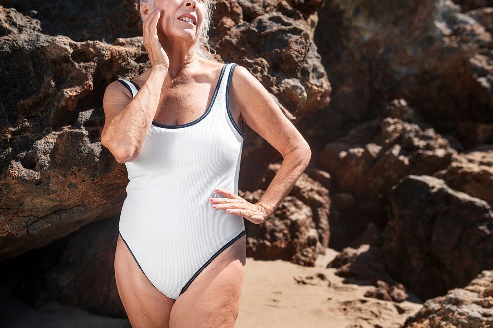 Senior woman in white one-piece swimsuit summer shoot