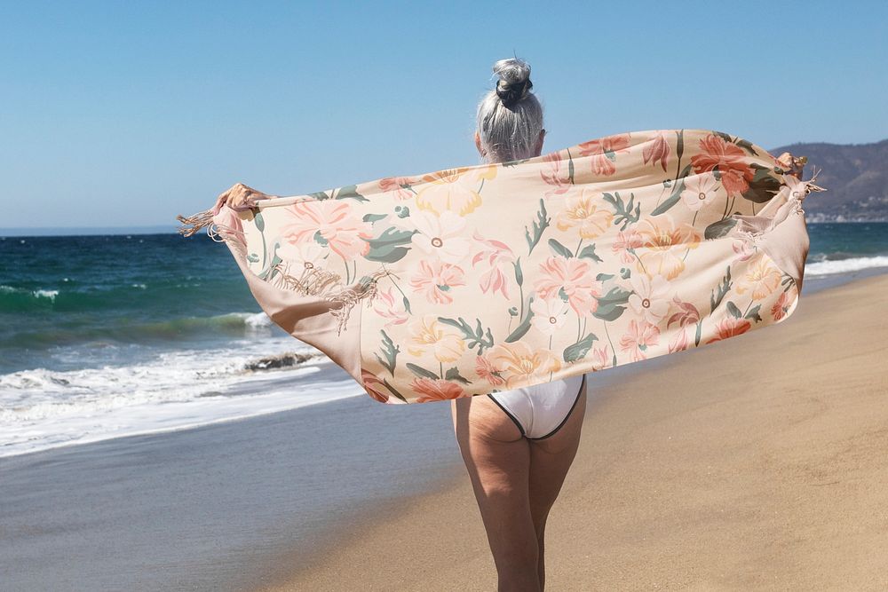 Orange floral scarf psd mockup with woman on the beach