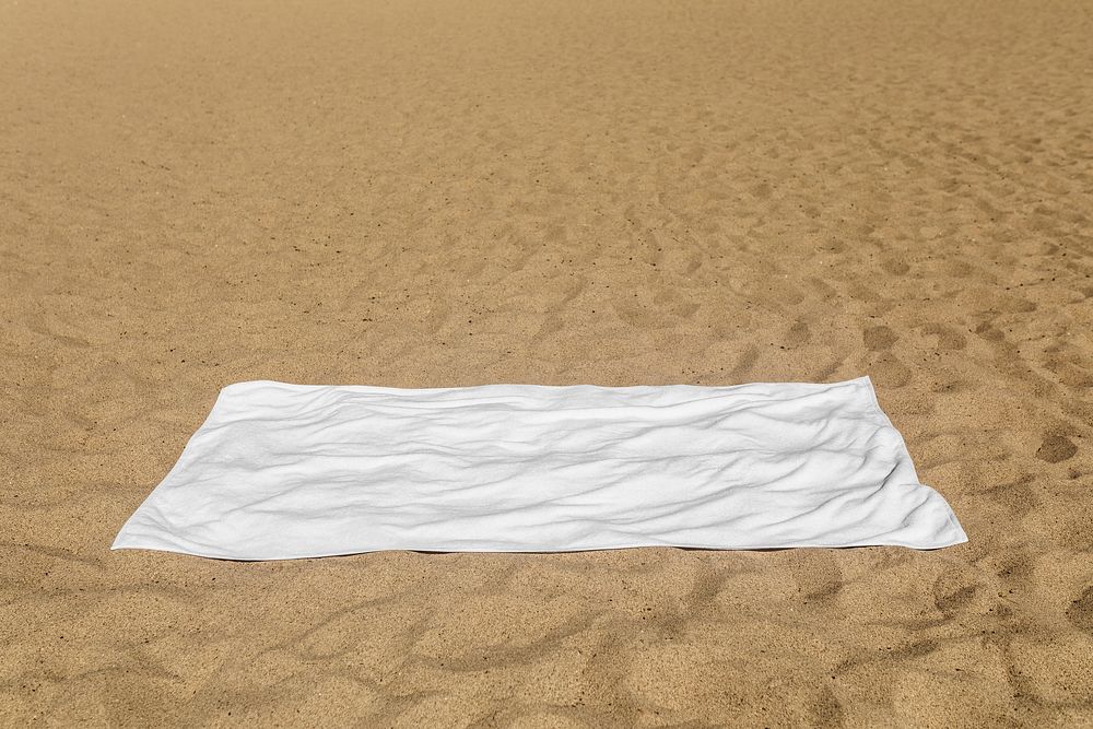 White beach towel on the sand