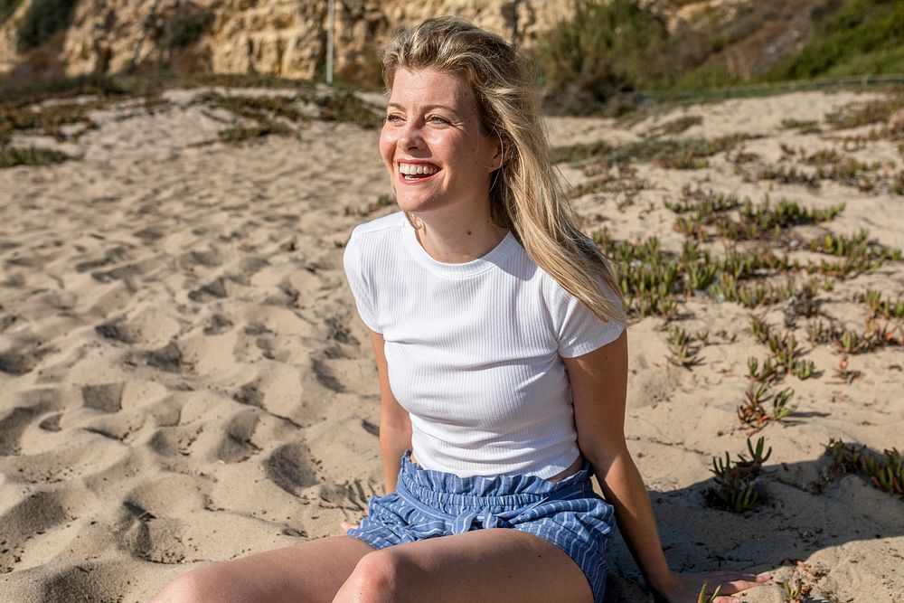 Happy woman in white top beach photoshoot