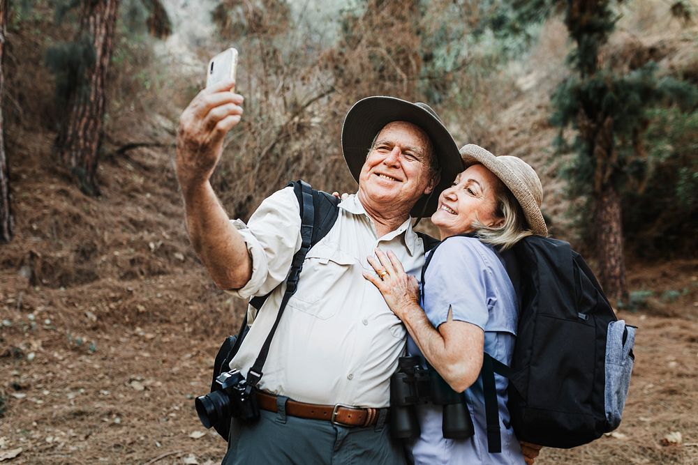 Senior partners taking selfie in the forest 