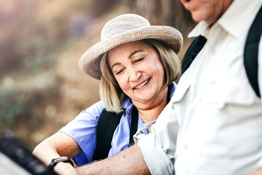 Happy elderly woman looking for direction with her husband 