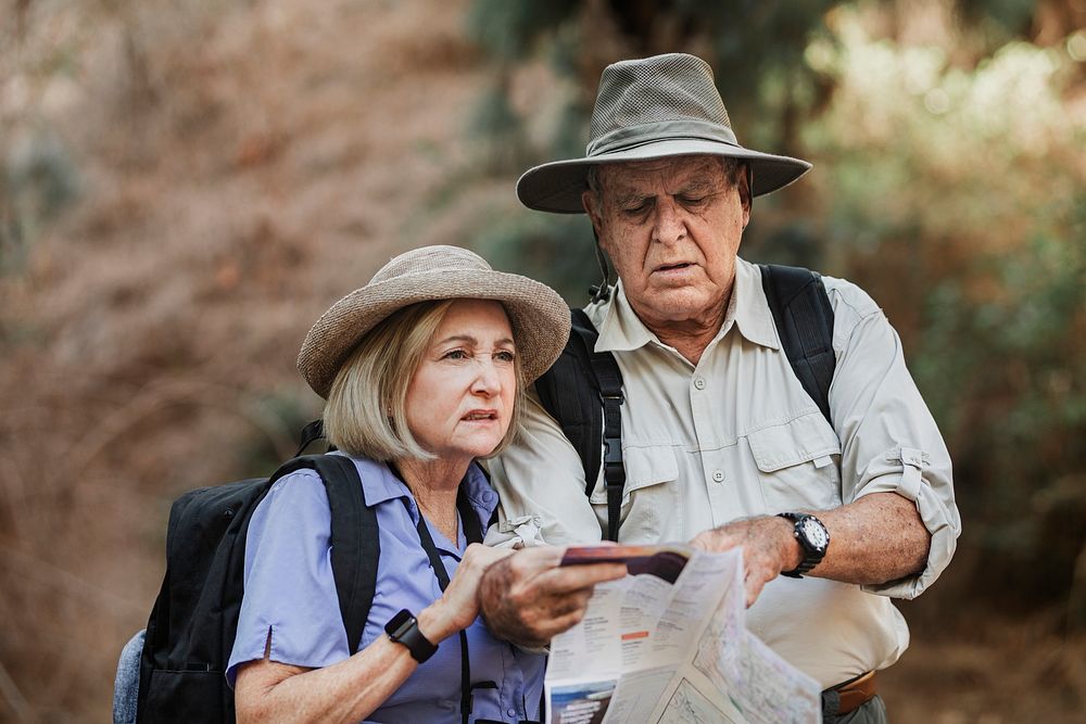 Lovely elderly couple using a map to search for direction
