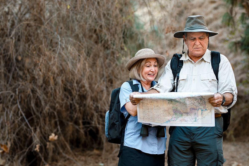 Lovely senior couple using a map to search for direction