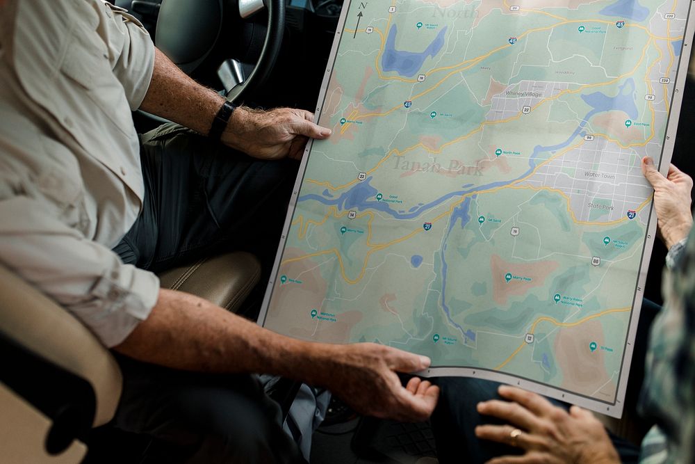 Senior couple searching for direction on a map 