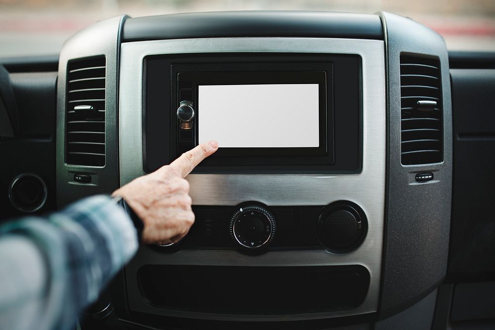 Finger pressing on white touch screen car stereo