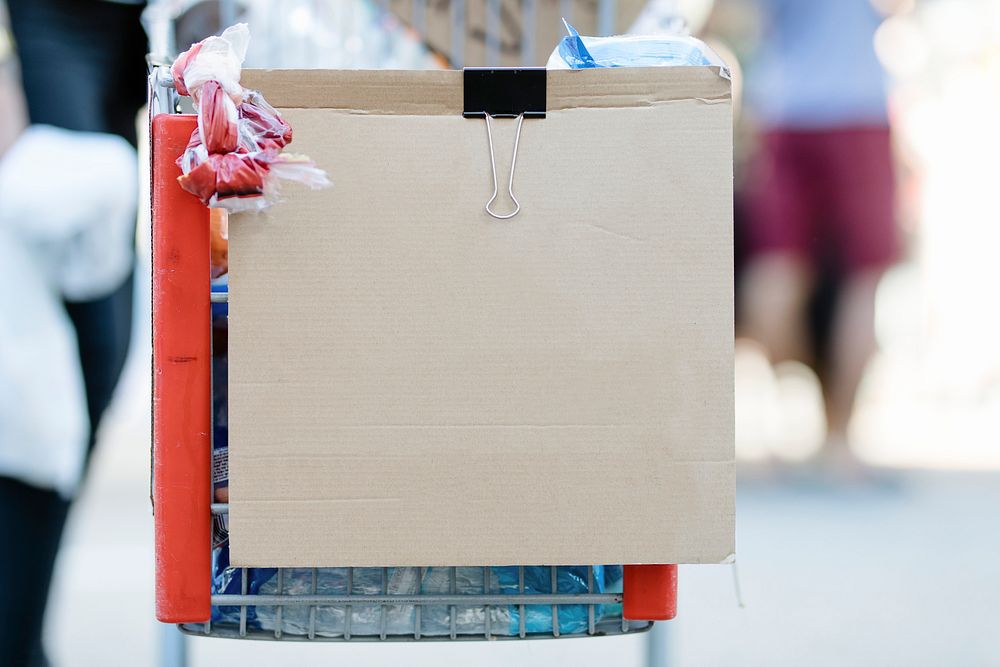 Brown cardboard with copy space clipped on a shopping cart 