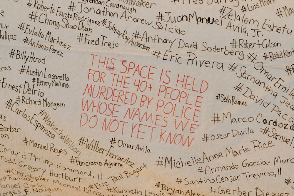 This space is held for the 40+ people murdered by police whose names we do not yet know banner at a Black Lives Matter…