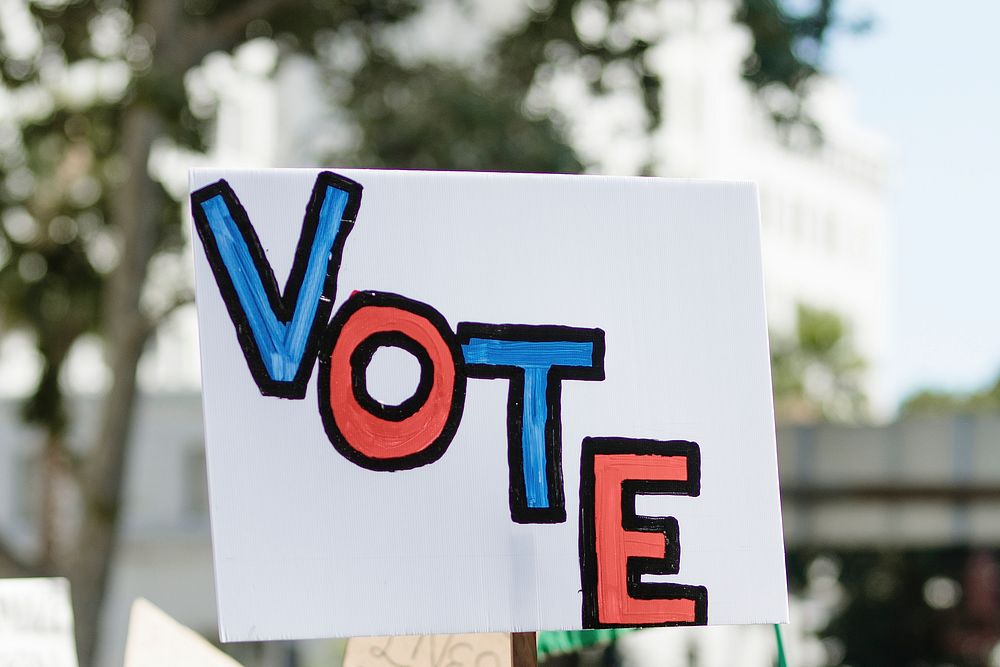Vote typography on a white placard at a black lives matter protest 