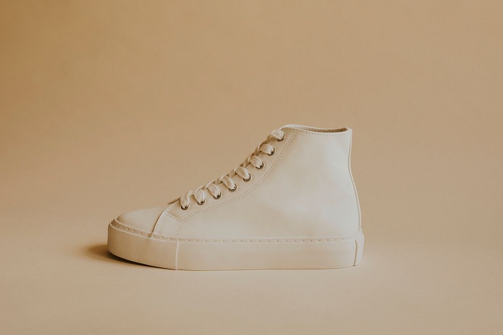 White high top sneakers on beige